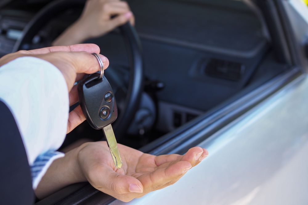 car-dealer-handing-over-the-keys-to-the-new