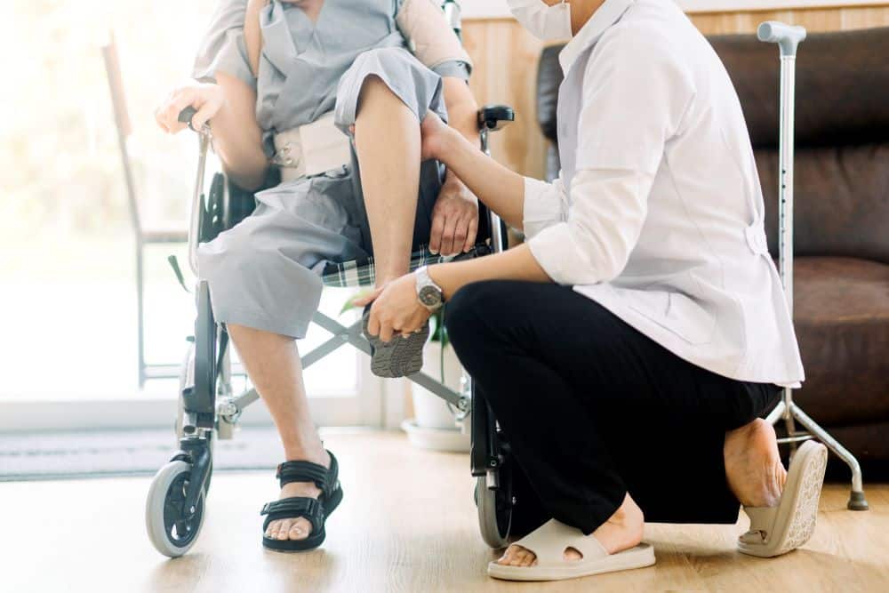 physiotherapist-helping-senior-woman