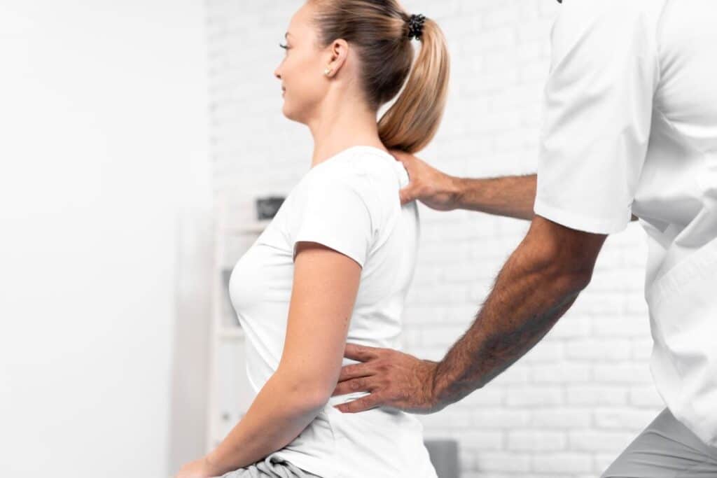 male-physiotherapist-checking-woman-s-back